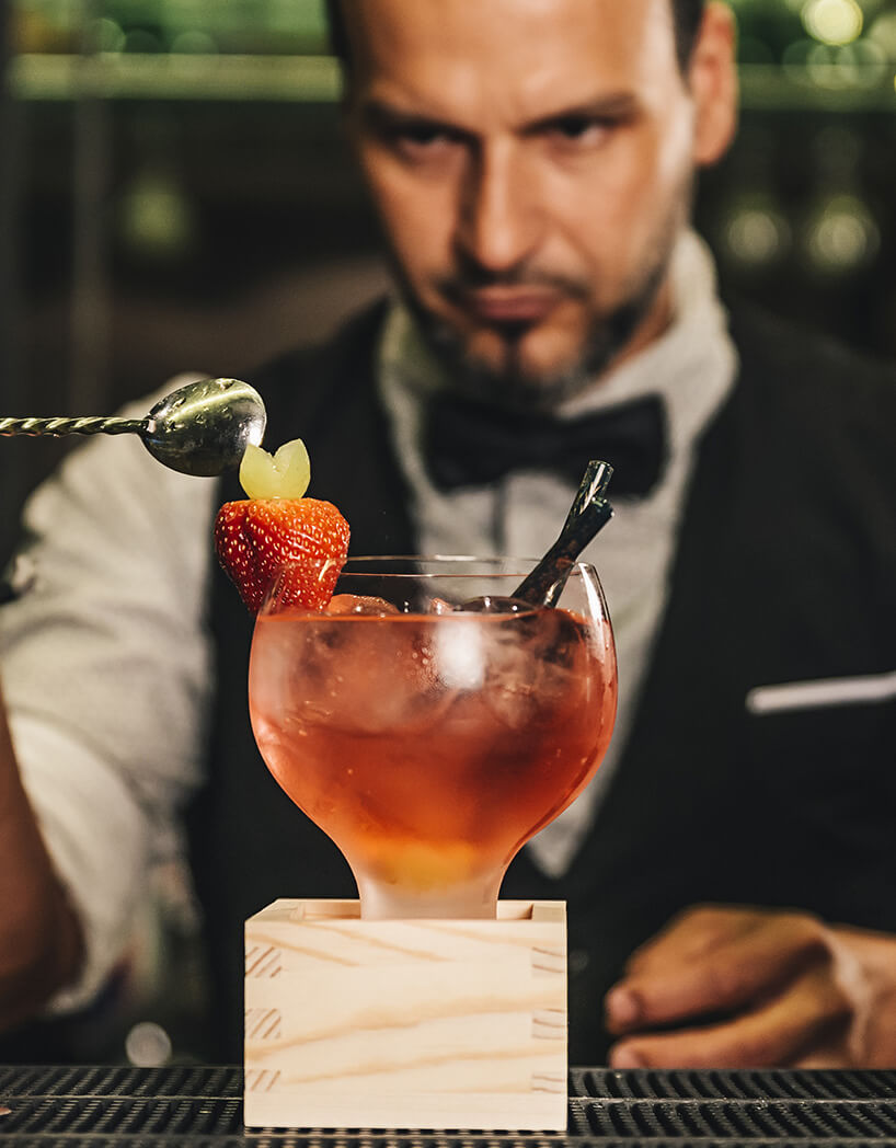 Barman pouring cocktail